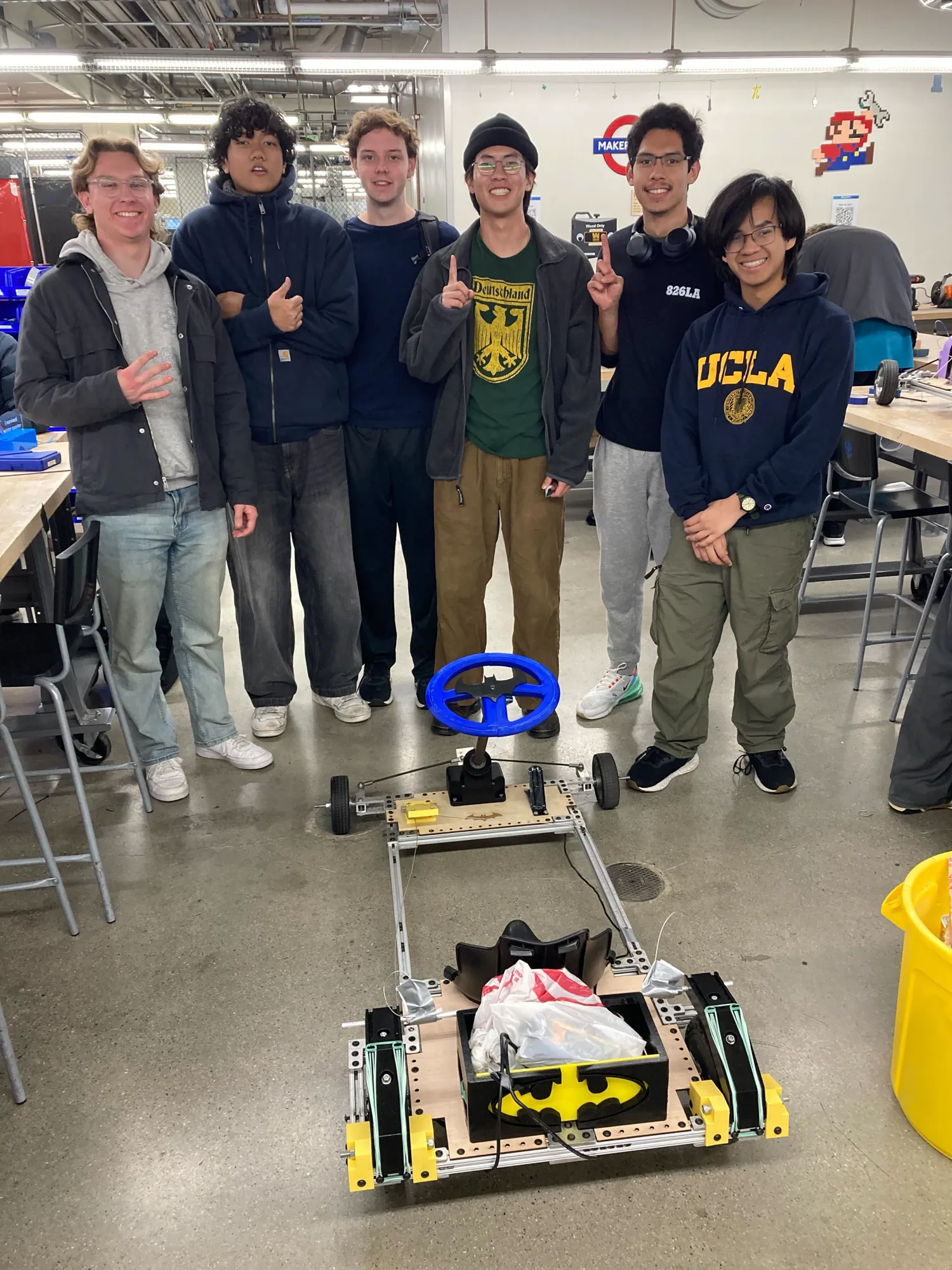 The team standing behind the Batman-themed go-kart