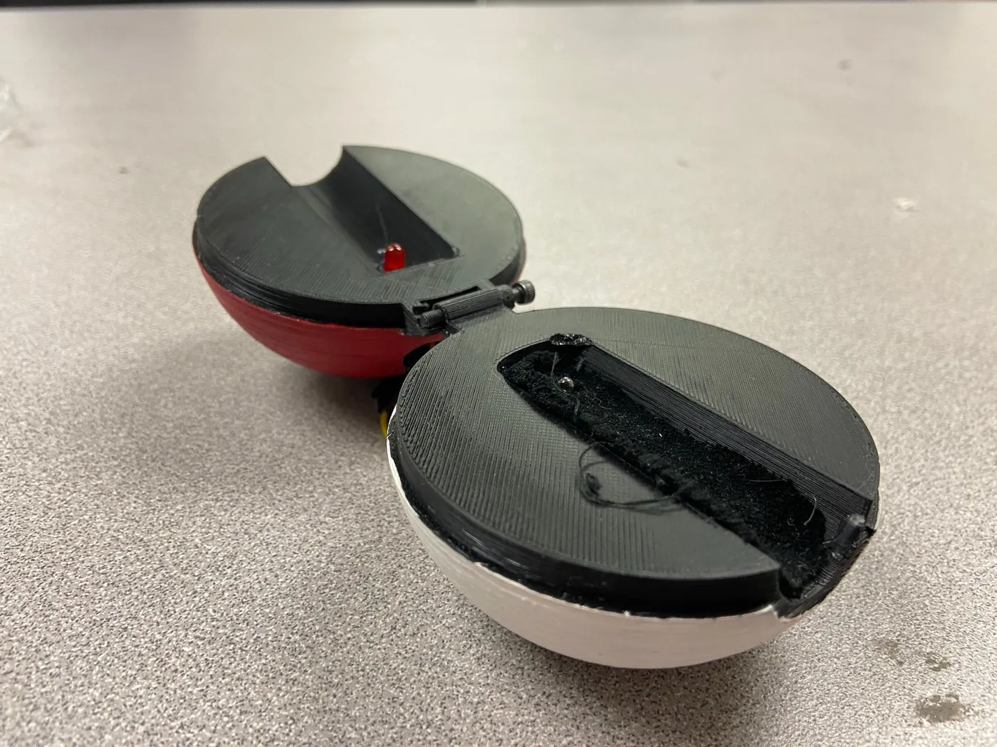 Completed pulse oximeter in a 3D-printed Poké Ball case